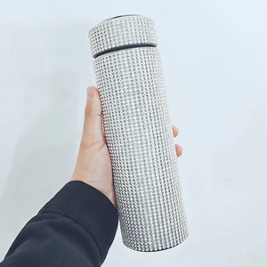 Detail showing hand holding a 500ml silver rhinestone insulated smart cup with LED display