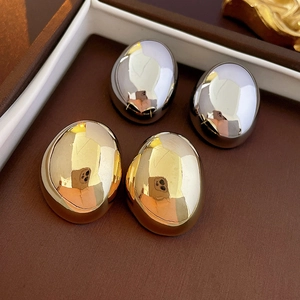 Polished oval pebble stud earrings in gold and silver finish with mirror reflection