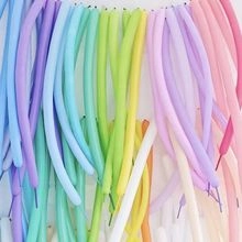 Close-up of colorful long latex balloons in pastel shades for party decoration