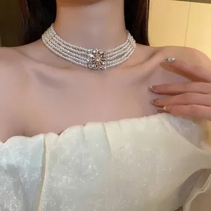 Five-layer pearl choker necklace with a sparkling rhinestone flower centerpiece accessory