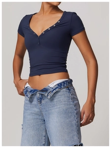 Detail of navy blue V-neck fitness tee with metal buttons and stylish denim waist design