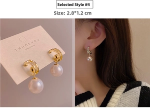 Detail view of gold hoop earrings with white crystals and large pearls, size 2.8x1.2cm