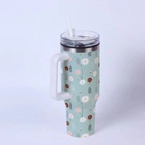 Detail of 40oz stainless steel tumbler featuring mint green floral daisy print and handle