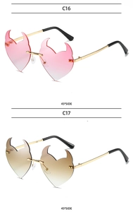 Detail view of heart-shaped devil horn sunglasses in pink and brown gradient lenses