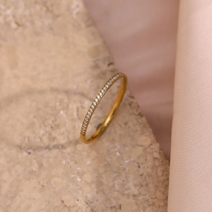 Detail shot of a 18K gold plated eternity ring with micro-pave cubic zirconia on stone