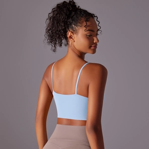 Close-up back view of a light blue yoga vest with thin straps and a slim-fit design