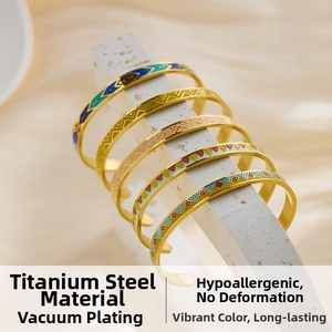 Macro detail of five titanium steel open bangles with colorful geometric enamel patterns
