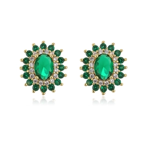 Close-up of vintage sunflower stud earrings with green emerald zircon and 18K gold plating