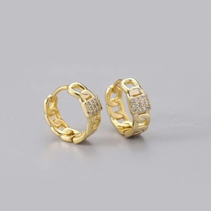 Detailed close-up of golden chain hoop earrings featuring a square zircon stone inlay
