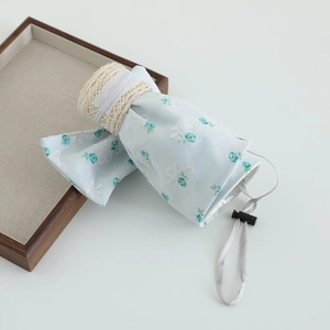 Detail of foldable sun hat with blue floral lace and adjustable elastic drawstring