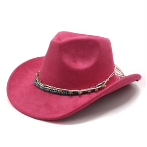 Detail of hot pink suede cowboy hat with ethnic beaded band and wide curved brim