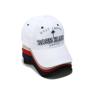 Set of stacked cotton baseball caps in white, beige, red, navy, and black with palm embroidery