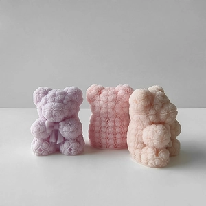 Detailed view of rose textured bear molds in purple, pink, and apricot wax materials