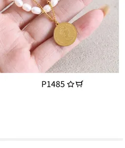 Detail of gold Elizabeth II coin pendant necklace with half pearl and metal chain