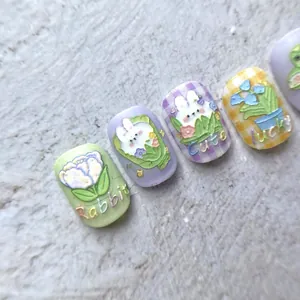 Macro view of 5D embossed nail stickers featuring cute rabbits and tulip floral designs