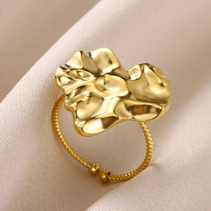 Detailed shot of a gold irregular petal-shaped ring with a twisted adjustable band