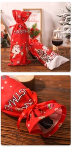 Close-up of red Christmas wine bottle bag with Santa print and ribbon drawstring detail