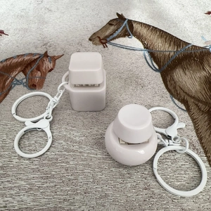 Close-up of square and round mechanical switch fidget toys with metal keychains