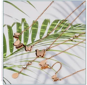 Detailed view of rose gold butterfly necklaces and bracelets with crystal accents
