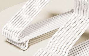 Close-up of white non-slip hangers stacked with a minimalist Nordic design for storage