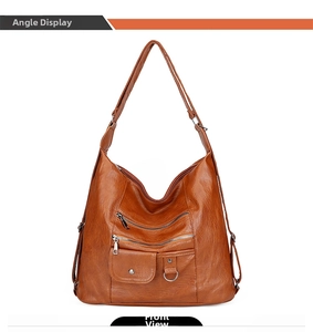 Front view of large brown faux leather tote with multiple functional zipper pockets