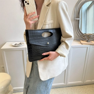 Fashionable black crocodile pattern tote bag with gold button closure and cutout handle