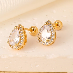 Macro shot of gold pear-shaped stud earrings with clear zircon and screw back