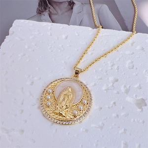 Detailed shot of Virgin Mary pendant with pearls, cubic zirconia, and gold rope chain