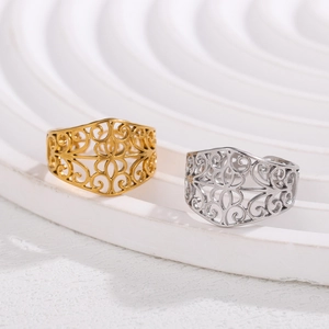Hollow patterned stainless steel rings in gold and silver finish on display