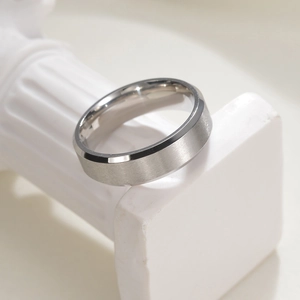 6mm minimalist silver stainless steel ring with brushed surface on white Roman column