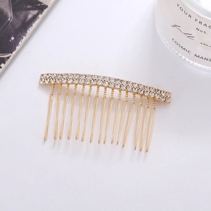 Detail of elegant gold comb featuring double rows of sparkling rhinestones for bridal hair
