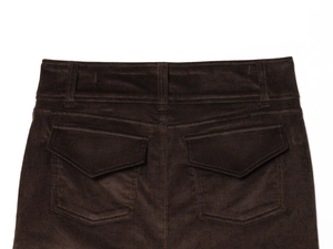 Detailed close-up of dark brown corduroy mini skirt featuring dual back pockets and waist seams