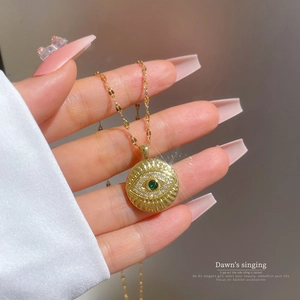 Luxurious gold titanium steel necklace with a green zircon evil eye round pendant