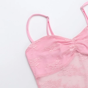 Detail of pink lace mesh strap dress showing delicate fabric texture and adjusters