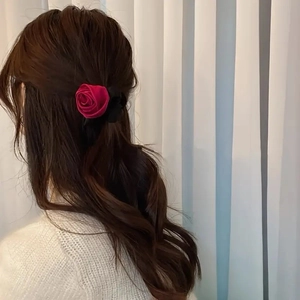 Elegant French satin rose hair scrunchie in deep red and black shown on a woman back view