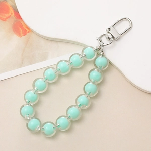 Detail of mint green transparent beads on a phone strap with a silver lobster clasp