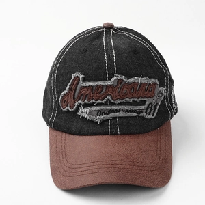 Detail of vintage baseball cap featuring denim splicing and suede brim with embroidery