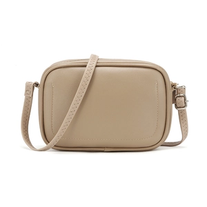 Close-up of minimalist khaki crossbody bag showing smooth leather texture and stitching