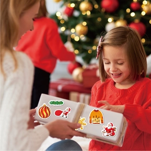 Holographic Christmas stickers featuring Santa and festive patterns on a white gift box