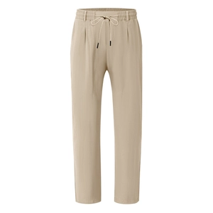 Detailed view of khaki linen pants featuring an elastic waistband and black tipped drawstrings