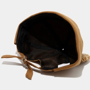 Detail of adjustable metal buckle and breathable interior lining on a brown sailor cap