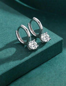 Close-up of S925 sterling silver hoop earrings with brilliant-cut diamonds in a gift box