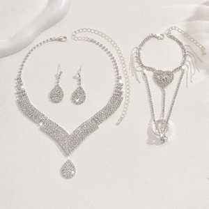 Luxurious silver bridal jewelry set with V-shaped necklace, teardrop earrings, and ring bracelet