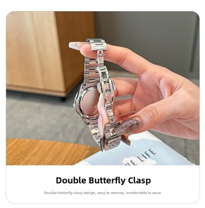 Detail of silver steel watch band featuring a double-press butterfly buckle clasp