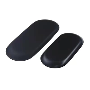 Detail of two smooth oval black basalt massage stones for spa treatment on white background
