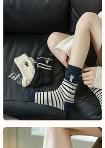 Detail showing bunny embroidery and striped patterns on cotton mid-calf socks