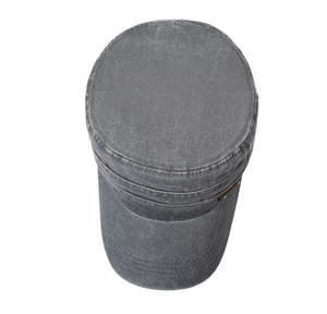 Detail of vintage washed cotton cadet cap in dark grey with metal logo and fine stitching