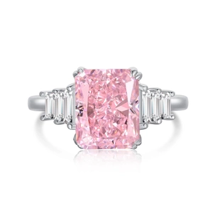 Macro shot of the rectangular pink gemstone and trapezoid side diamonds on a silver ring