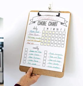 Close-up of wooden A4 clipboard featuring a Chore Chart for daily task organization