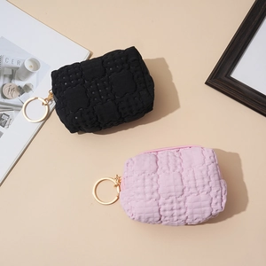 Pastel waffle texture coin purses in black and pink with stylish gold ring zippers